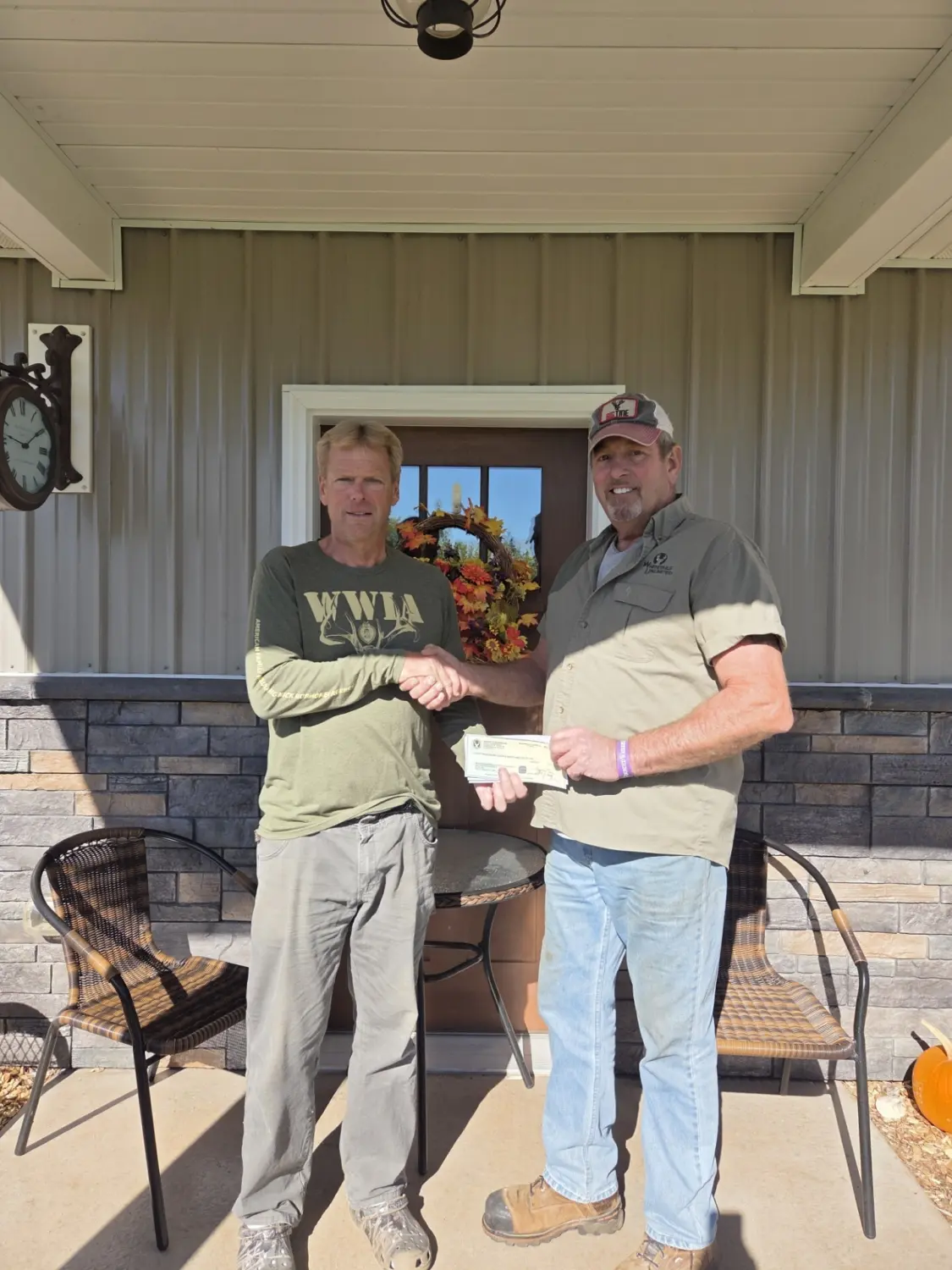 Jim Klobucher on the right is presenting a check to WWIAF associate Danny Bourassa